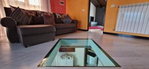 a living room with a couch and a glass table at Vila Bijou in Borşa