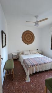 a bedroom with a bed and a ceiling fan at Casa Lola Preciosa azotea vistas panorámicas in Almuñécar