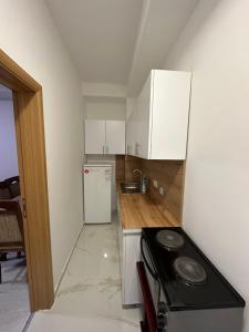 a small kitchen with a stove and a refrigerator at D&M Apartments in Struga