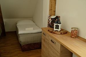 a small room with a bed and a wooden desk at Apartmány Bolevec Plzeň pro rodiny s dětmi a zvířátky in Plzeň