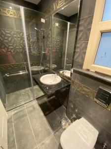 a bathroom with a toilet and a sink at Hacienda Bay Luxury Chalet هاسيندا باي in El Alamein