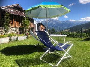 a blue chair and a table and an umbrella at La Ville CIR 00002 in Allein