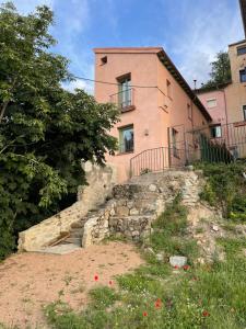 una casa rosa con escaleras que conducen a ella en La Atalaya, en La Granja de San Ildefonso