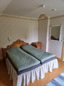 a bedroom with a large bed in a room at Gamla Kooperativa in Ekshärad