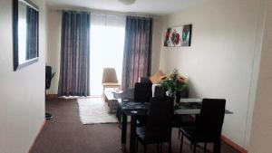 a dining room with a table and chairs and a window at Menlyn Bizcation Accommodation in Pretoria
