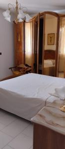 a bedroom with a large bed with a white mattress at Villa Bellino in Castellana Grotte