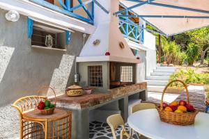 a outdoor kitchen with a table and chairs at CalmNature in Agnontas