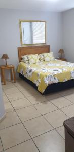 a bedroom with a bed and a tiled floor at Rietvlei at Margate Boulevard in Margate