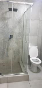 a bathroom with a shower and a toilet at Rietvlei at Margate Boulevard in Margate
