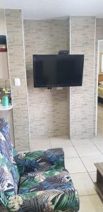 a living room with a couch and a flat screen tv at Rietvlei at Margate Boulevard in Margate