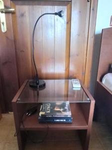 a desk with a lamp and a book on it at Katerina's Houses #2 in Alonnisos Old Town +60 photos