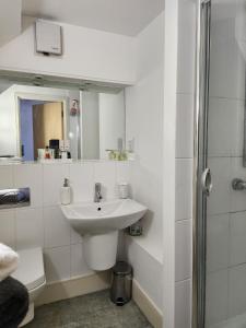 a white bathroom with a sink and a shower at Holiday Let Mistley in Mistley