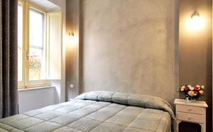 a bedroom with a bed and a window at All'Operetta di Cagliari in Cagliari
