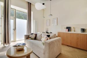a living room with a couch and a table at Luxury apartment 5P1BR - Square des Batignolles in Paris