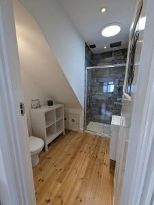 a bathroom with a toilet and a glass shower at Arawak in Kent