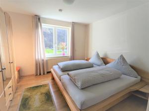 a bed in a room with a window at Haus Landlust in Edersee