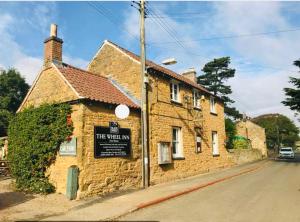 a brick building on the side of a street at The Stables Coach Home 