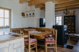 a kitchen with a wooden table and chairs at Weinberg Chalet Kokumandl in Winten