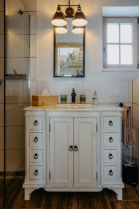 a bathroom with a white sink and a mirror at Weinberg Chalet Kokumandl in Winten