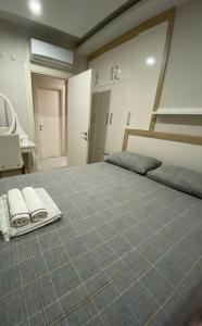 a bedroom with a bed with two towels on it at Lara Kundu Oteller Bölgesi in Aksu