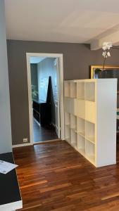 a living room with a book shelf and a staircase at Eiganesveien 1/sentralt,2 sov. in Stavanger