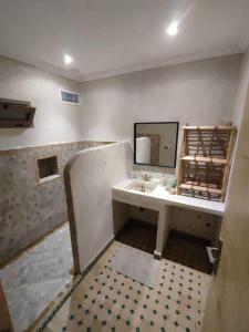 a bathroom with a sink and a mirror at Magnifique maison en pierre 