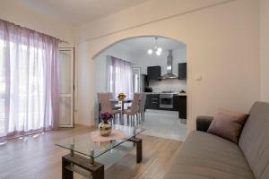 a living room with a couch and a table at Bugenvilija apartment in Brna