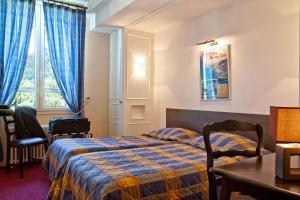 Postel nebo postele na pokoji v ubytování Hôtel et Résidence des Bains + 37 fotografií