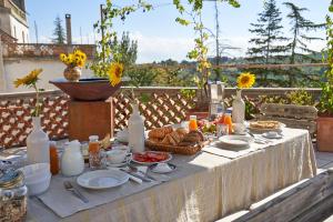 a table with plates of food and a basket of bread at Villa Cartoceto in Cartoceto