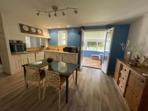 a kitchen with a table and a dining room at Le Cocon des SPRESS in Cers