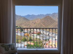 a window with a view of a mountain view at Las Teresitas Apartment in San Andrés