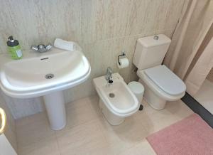 a bathroom with a white sink and a toilet at Las Teresitas Apartment in San Andrés