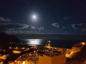a view of a city at night with the moon at Las Teresitas Apartment in San Andrés