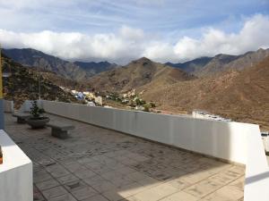 a balcony with benches and a view of mountains at Las Teresitas Apartment in San Andrés