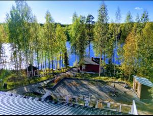 an aerial view of a house on the shore of a lake at Mökki unelmia in Jyväskylä