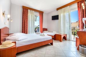 a bedroom with two beds and a balcony at Studios Maria in Potos