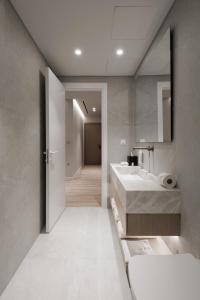 a bathroom with two sinks and a mirror at Nur Aparthotel Athens in Athens