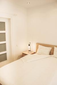 a bedroom with a bed and a lamp on a night stand at Apartamento 15' Barcelona centro in Santa Coloma de Gramanet