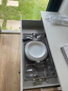 a cabinet with a plate and utensils in it at Tatsopus in Kamianets-Podilskyi
