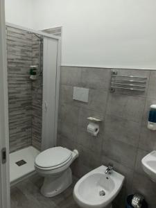 a bathroom with a toilet and a shower and a sink at Le Sirene in Brindisi