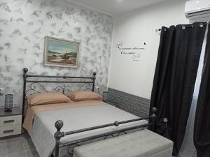 a bedroom with a bed and a picture on the wall at Le Sirene in Brindisi