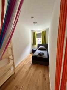 a small bedroom with a bed and a window at Reeperbahn Apartments in Hamburg