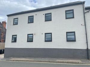 a white building with windows on the side of it at Middlecroft in Chesterfield