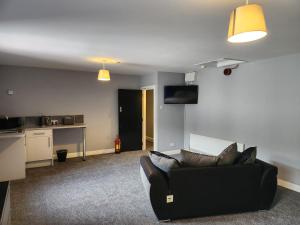 a living room with a couch and a kitchen at Kings Head in Chepstow