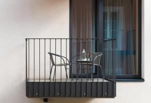 a table and chairs on a balcony with a window at master Linzergasse in Salzburg