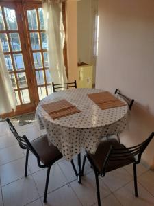 a table and chairs in a room with a window at Departamento Payún Matrú in Malargüe