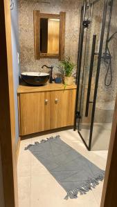 a bathroom with a sink and a mirror at Domek Ostoja Góry Sowie in Łomnica