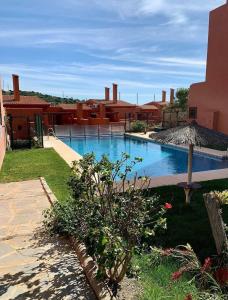 a swimming pool in the yard of a house at Apartamento de dos dormitorios y un baño con piscinas y jardines cercano a la playa in Estepona +6 photos