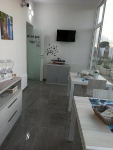 a living room with white walls and a television on the wall at Le Sirene in Brindisi