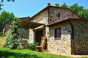 a stone house with a window and a door at Il Venaio in Massa Marittima